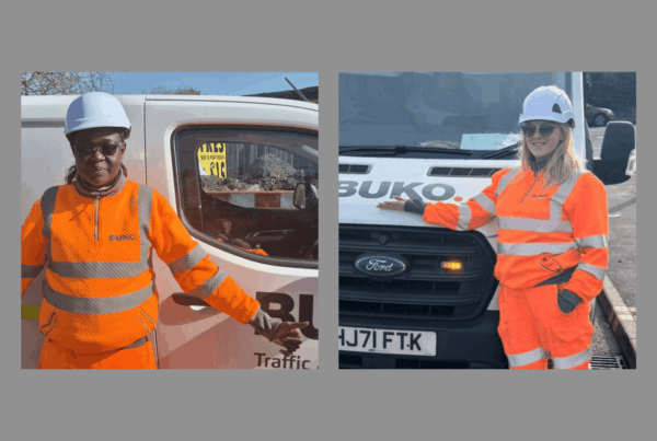 "Nancy and Aime, Traffic Management Operatives, standing confidently in high-visibility jacket and hard hat, representing women breaking barriers in traffic management.